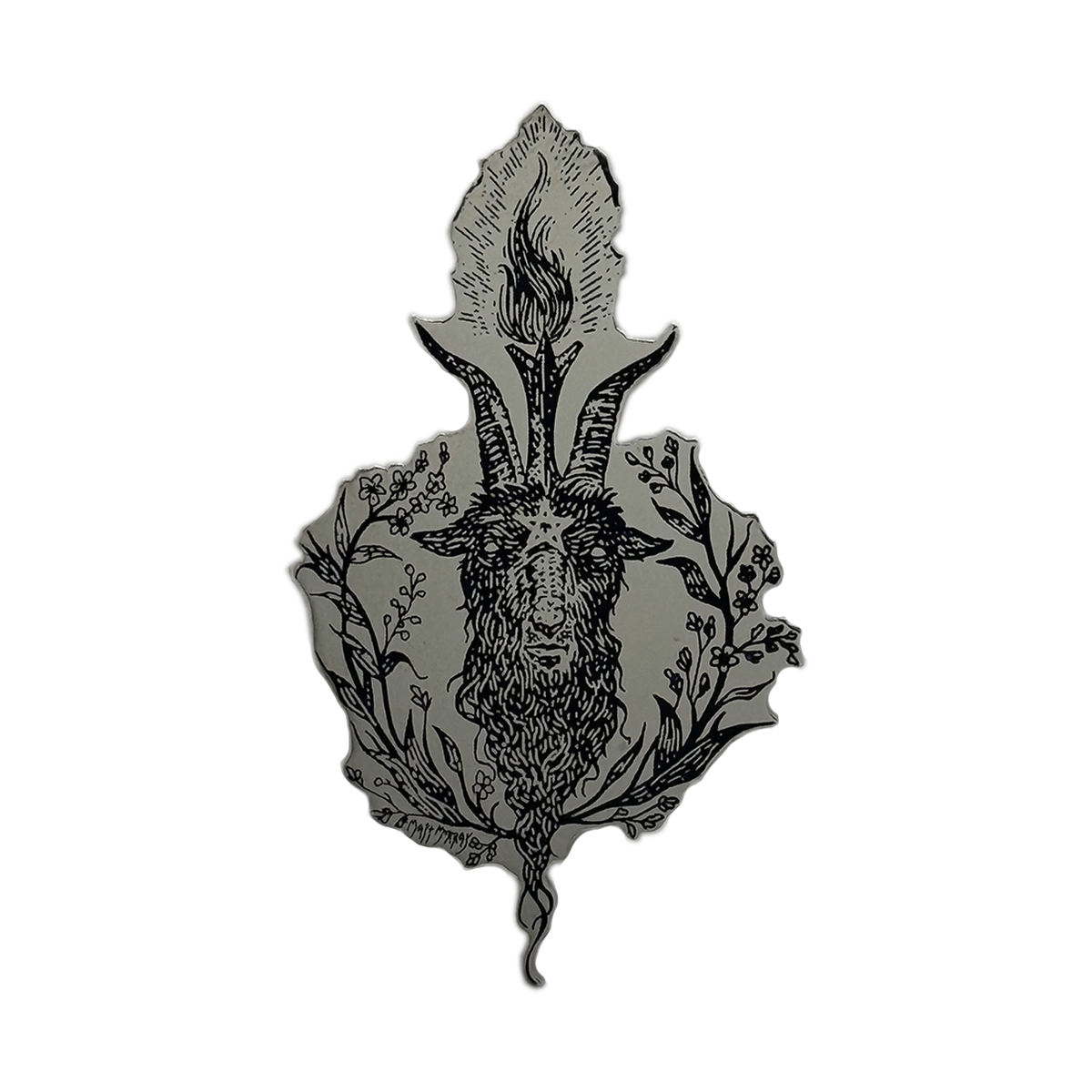 A black metal enamel pin featuring a detailed illustration of a goat head with prominent horns, surrounded by floral and leafy botanical elements, set against a solid gray background.