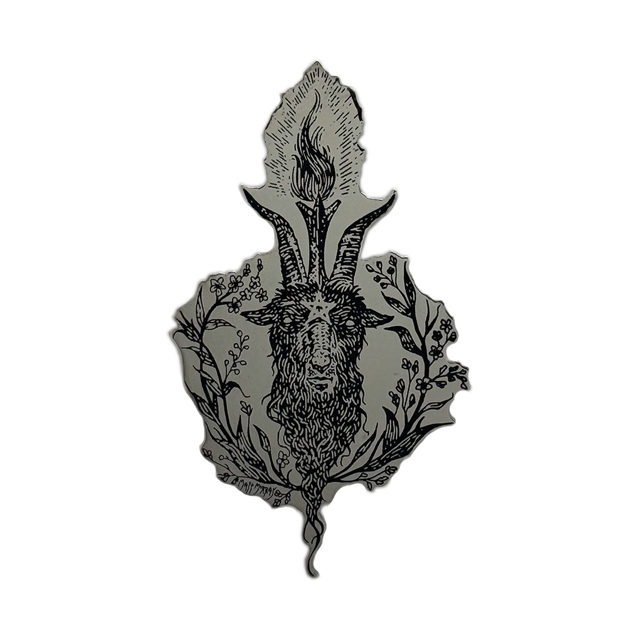 A black metal enamel pin featuring a detailed illustration of a goat head with prominent horns, surrounded by floral and leafy botanical elements, set against a solid gray background.