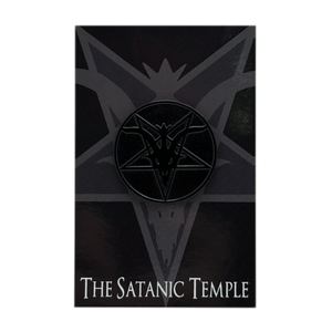 A black enamel lapel pin featuring The Satanic Temple Logo, mounted on a black display card with the text 'THE SATANIC TEMPLE' at the bottom.
