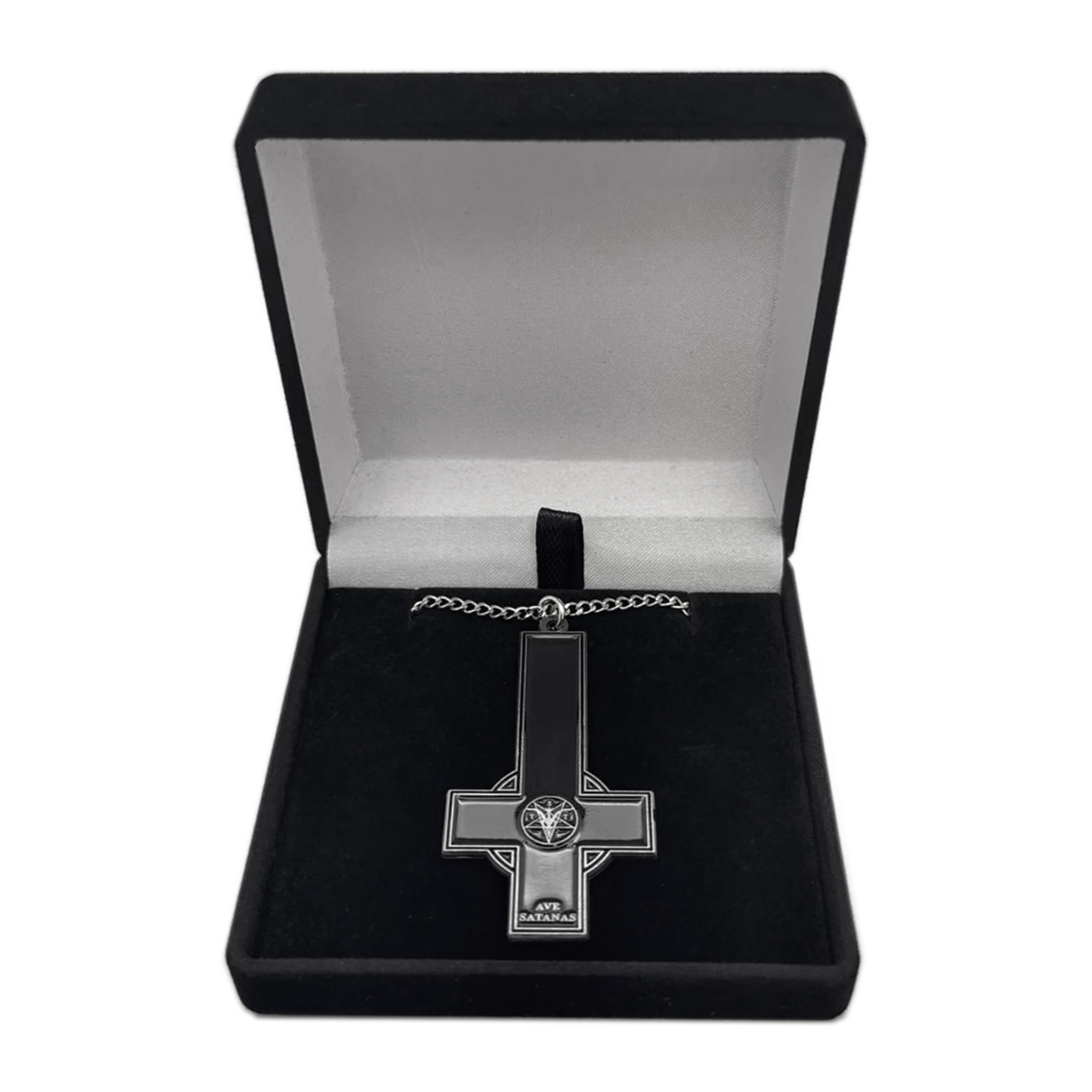 A gothic-style cross pendant necklace with a black enamel center and silver-toned metal borders, displayed inside an open black velvet jewelry box on a white background.