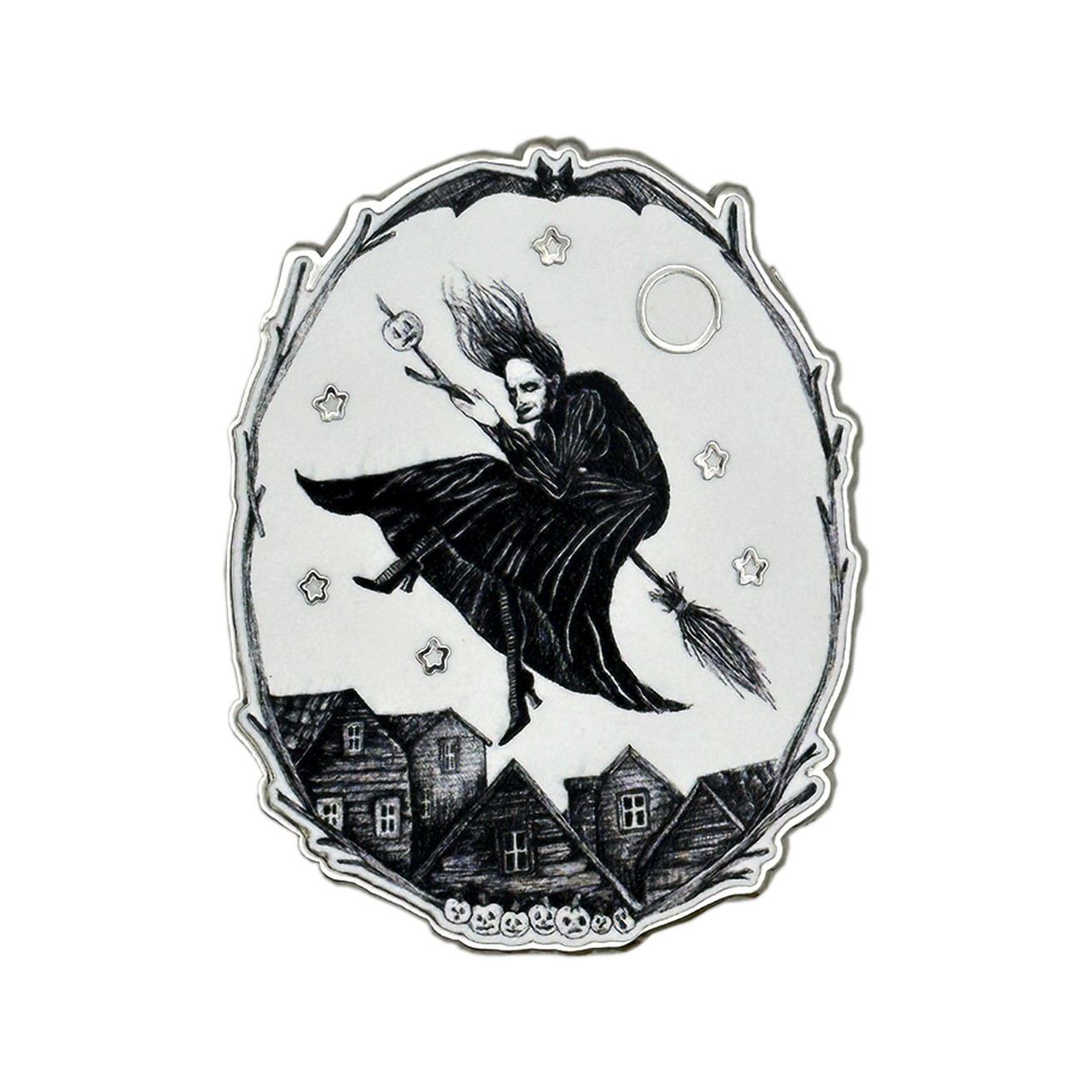 A silver-toned and white oval pendant or featuring a black illustration of a witch riding a broomstick over small houses under a full moon, with stars around the scene. Glows in the dark 